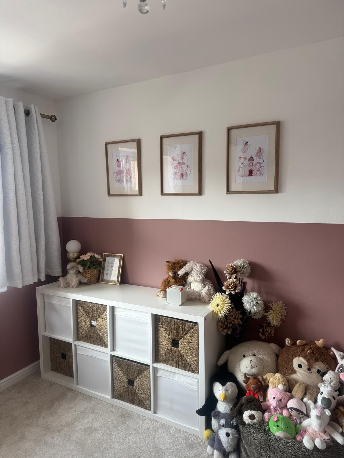 Child's bedroom with warm pink feature wall and house-shaped bed
